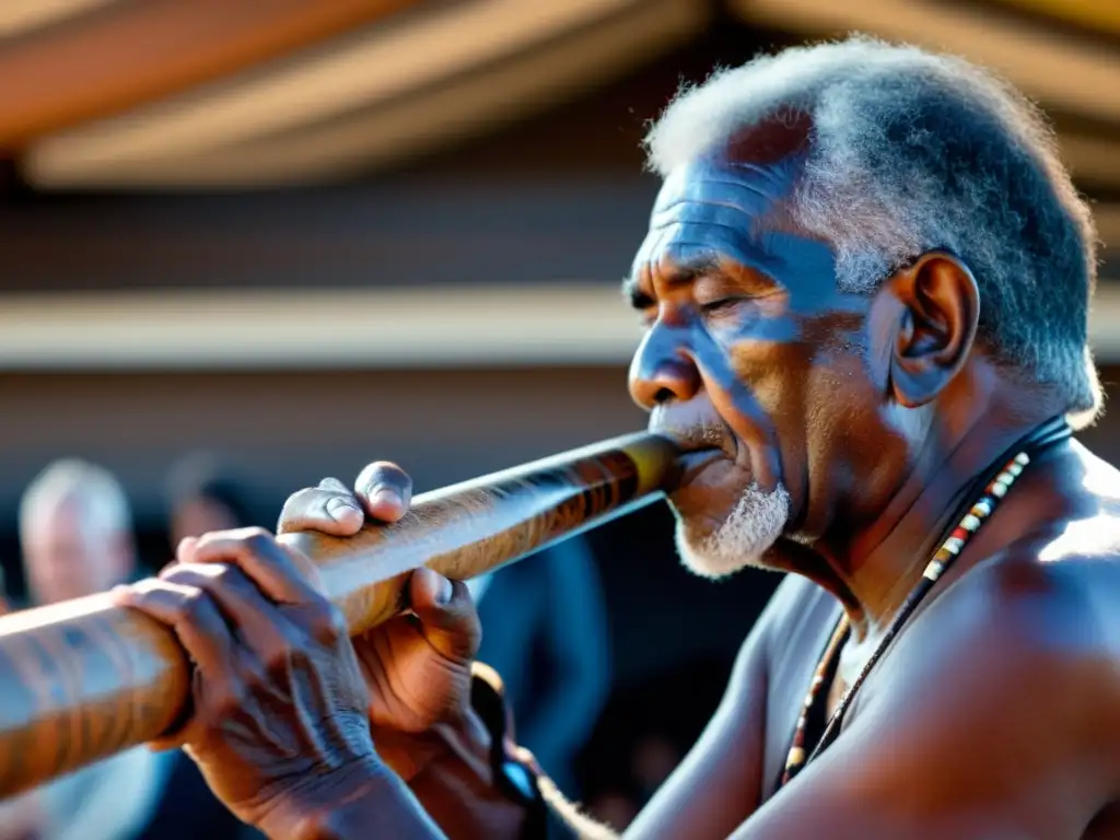 Un anciano aborigen toca el didgeridoo en un evento cultural, con bailarines modernos de fondo