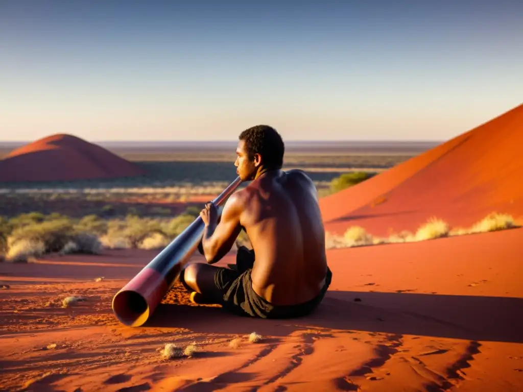 Un músico aborigen australiano toca el didgeridoo en el vasto paisaje del Outback